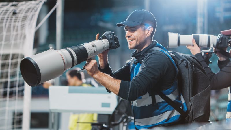 Photographer takes photos at a sporting event