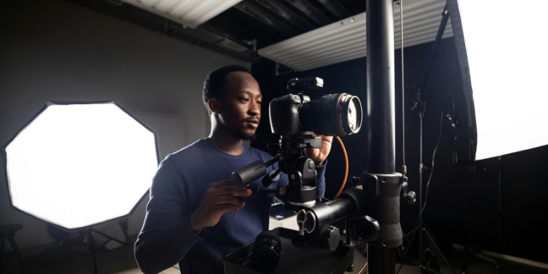 Student setting up a camera in the UNF Photography lighting studio