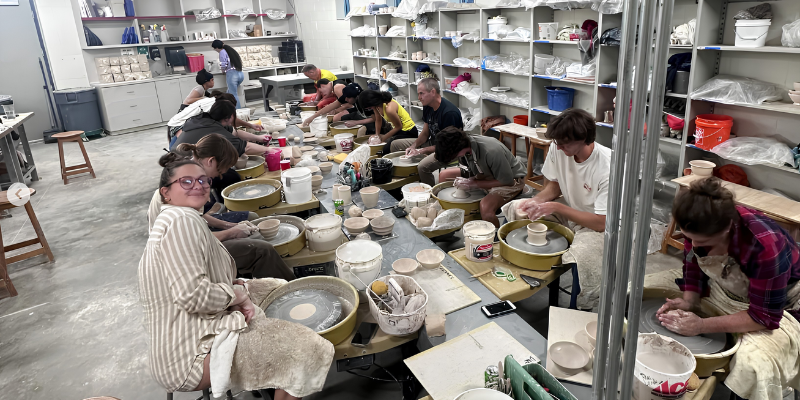 Students working at pottery wheels in the UNF Ceramics studio