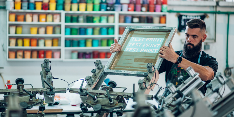 Student checking a screen in a Printmaking studio