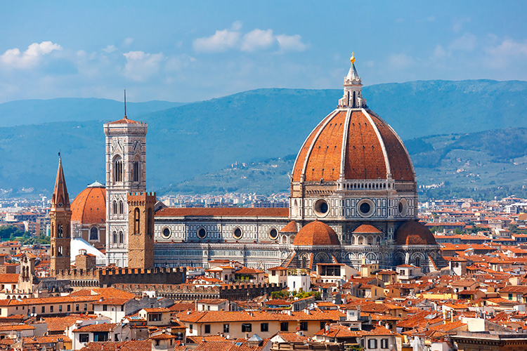 A scenic view of Florence's iconic Cathedral of Santa Maria del Fiore, featuring its large dome and surrounding medieval architecture.