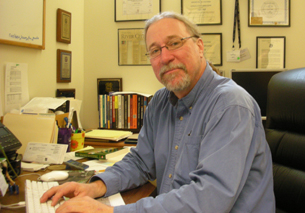 Dr. Jeffry A. Will sitting at his home office