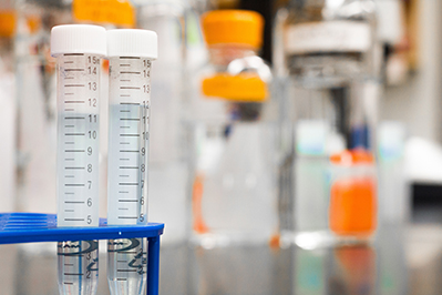 blurred metered containers in lab