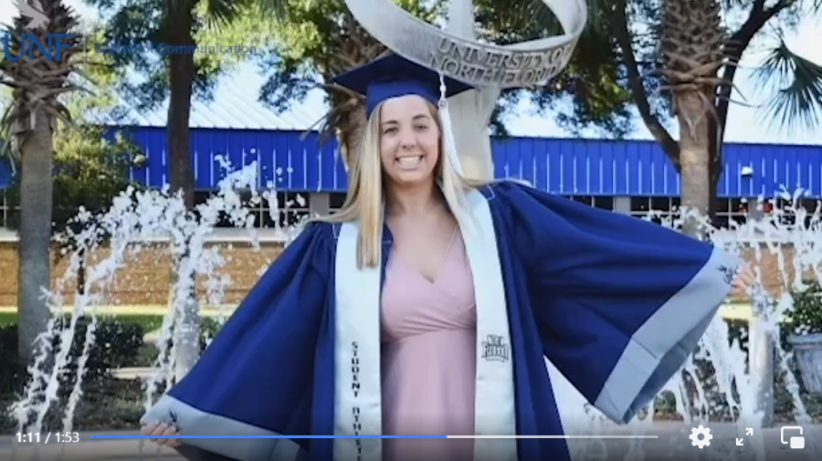 Photo shows Sarah Jorham in her cap and gown in front of a UNF fountain.