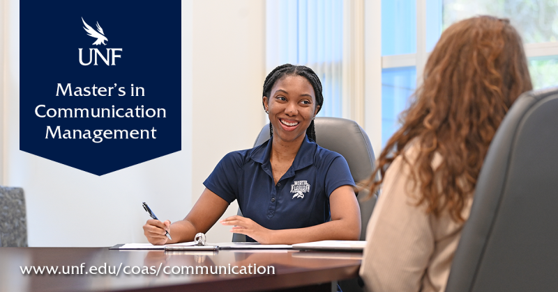 A student talks to a faculty member about the M.S. degree at a conference table