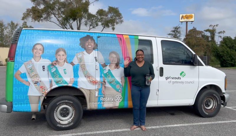 Patrice Abner stands beside the company van.