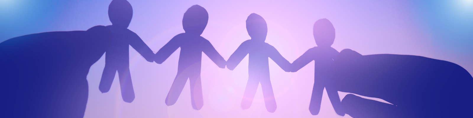 a chain of paper dolls holding hands is held to the light