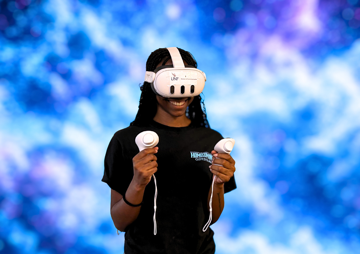 student smiles while using a VR headset