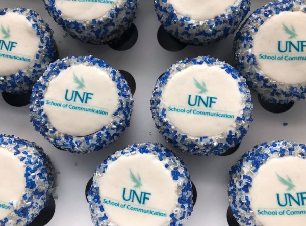 A picture of mini cupcakes with the UNF School of Communication logo printed on them
