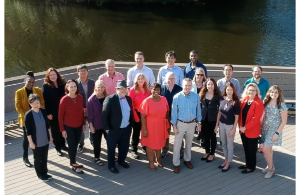 Faculty and staff pose for a photo on campus.