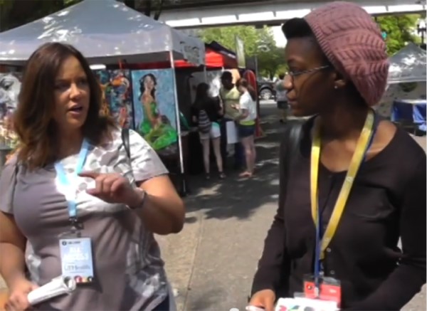 Ignite Media reporter speaks with a student at an outdoor event
