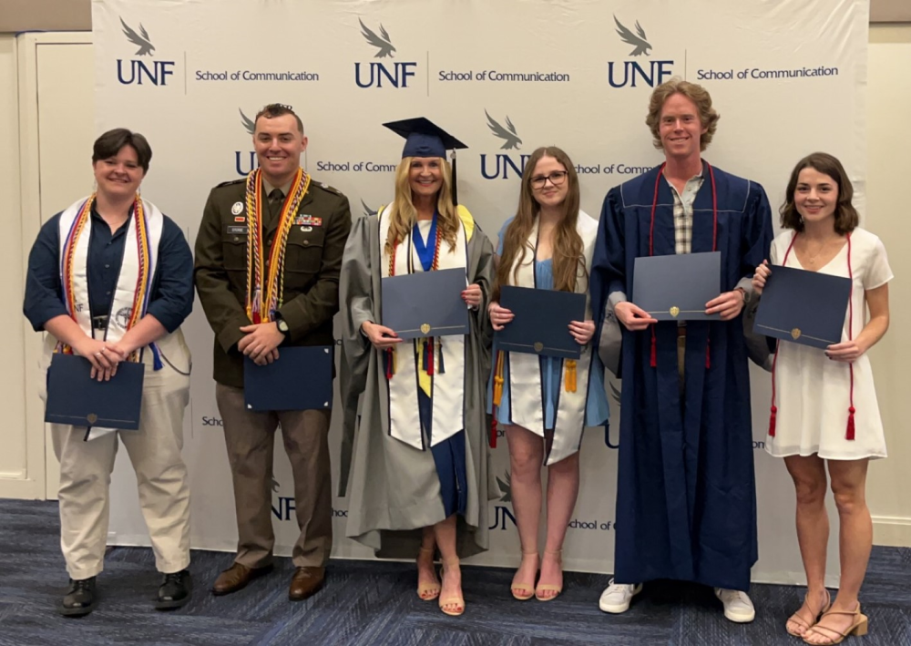 The 2023 Outstanding Students receive their awards on stage.