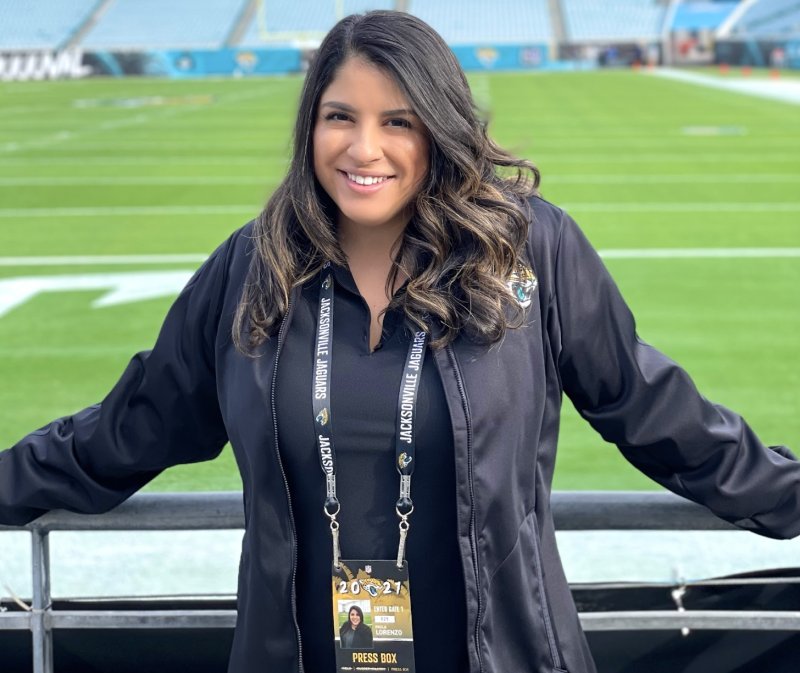 Paola Lorenzo standing in front of a football field.
