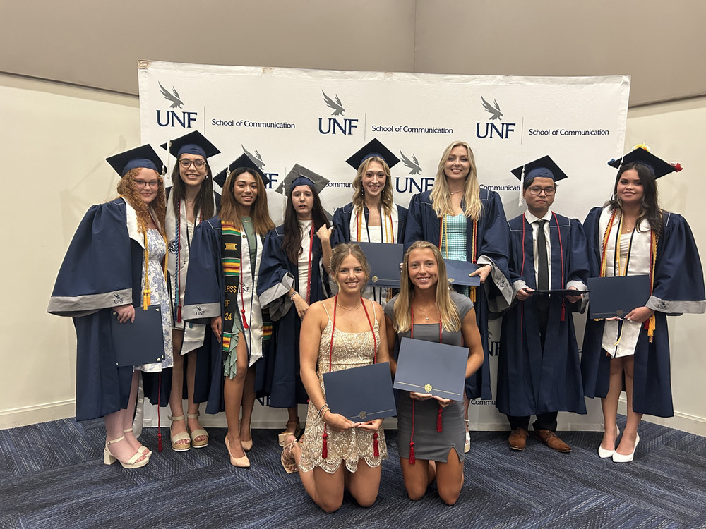 Outstanding students and ambassadors hold their awards.