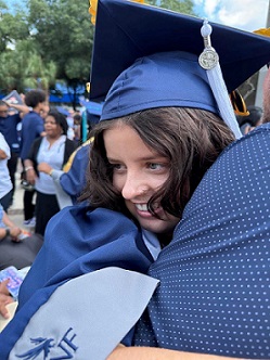 Kaylee Gumz at graduation being hugged