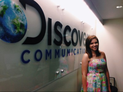 Madison Geery in front of Discovery Communication sign.