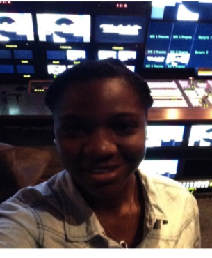 Ciara Thomas in the TV studio with the equipment and screens behind her.