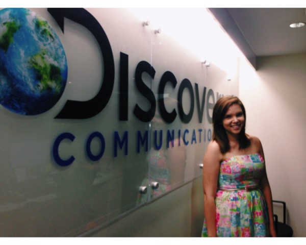 Madison Geery poses in front of the Discovery Communications sign in New York City.