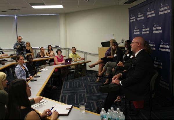Professionals talk with students at the Public Relations Breakout panel in the large classroom.