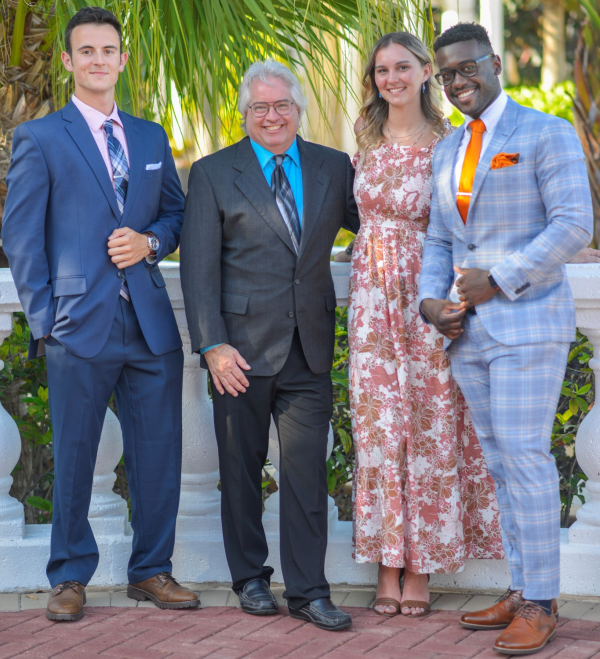 Professor Ken Thomas and three student award winners pose outside.