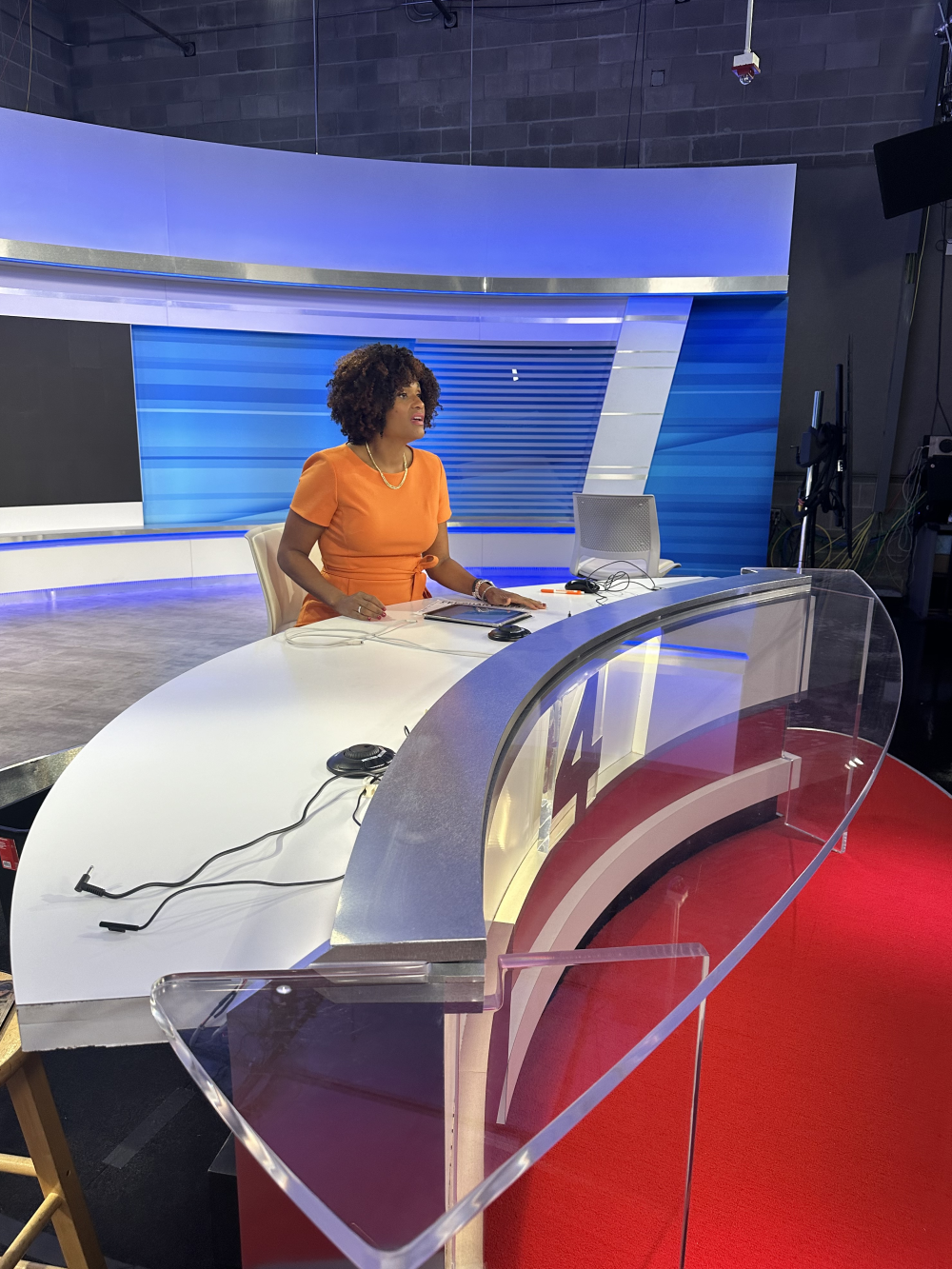 Melanie Lawson sits at the news desk inside WJXT TV studio.