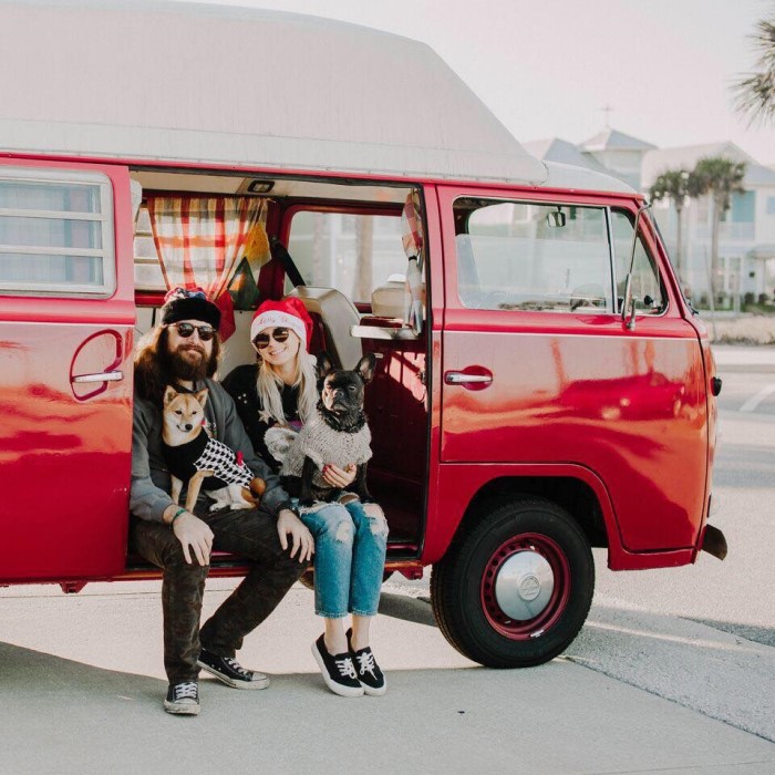 Zach Sweat and Haleigh Dunning in red van with two dogs. 