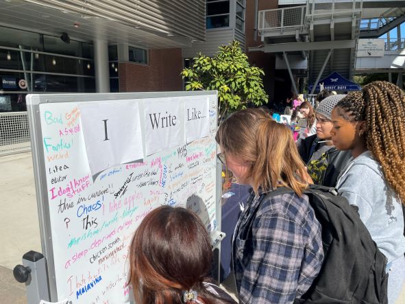 Students writing what they "write like" on a white board. 