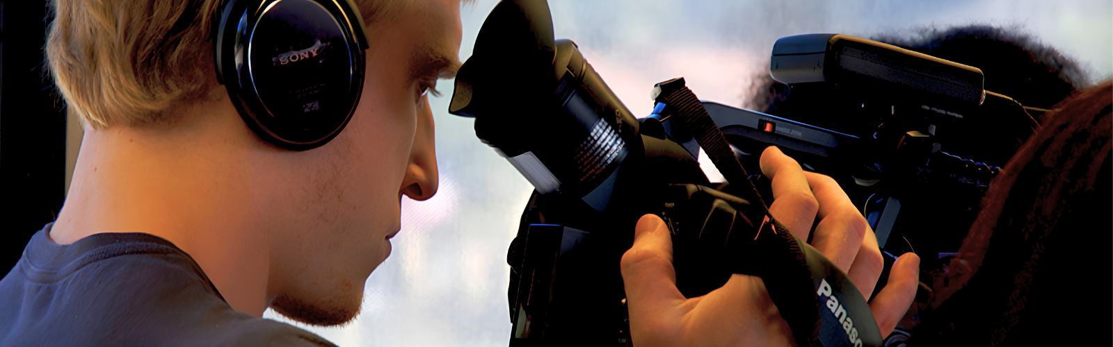 Student filming with a professional video camera