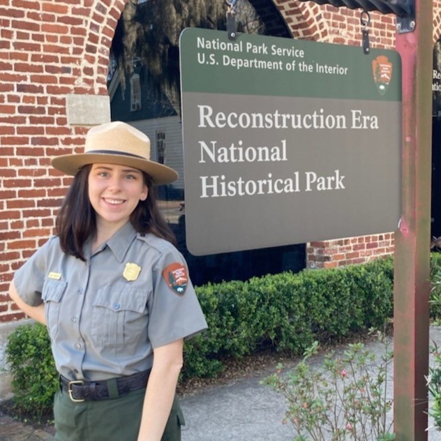 Kaley Crawford standing in front of the Reconstruction Era National Historical Park sign