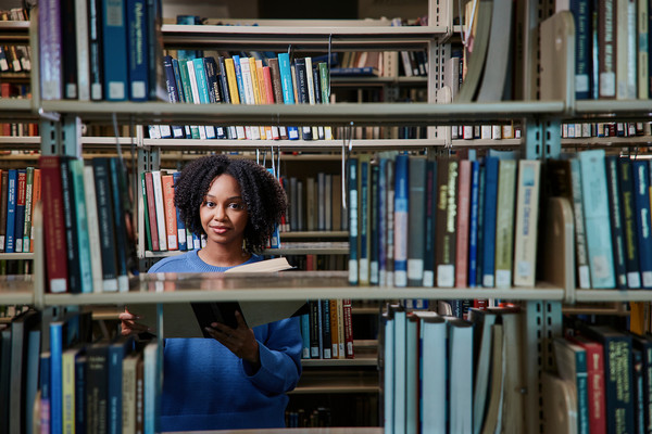 person in a library reading a book
