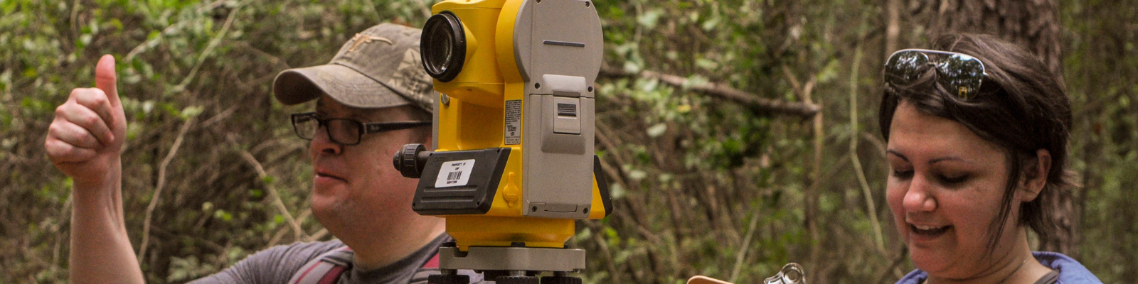 Students use surveying instrument during fieldwork