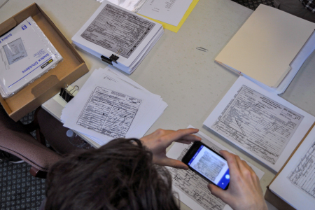 Student photographing historic records in archive