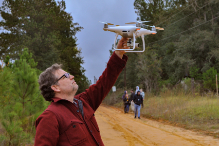 Researcher launching drone for aerial mapping survey