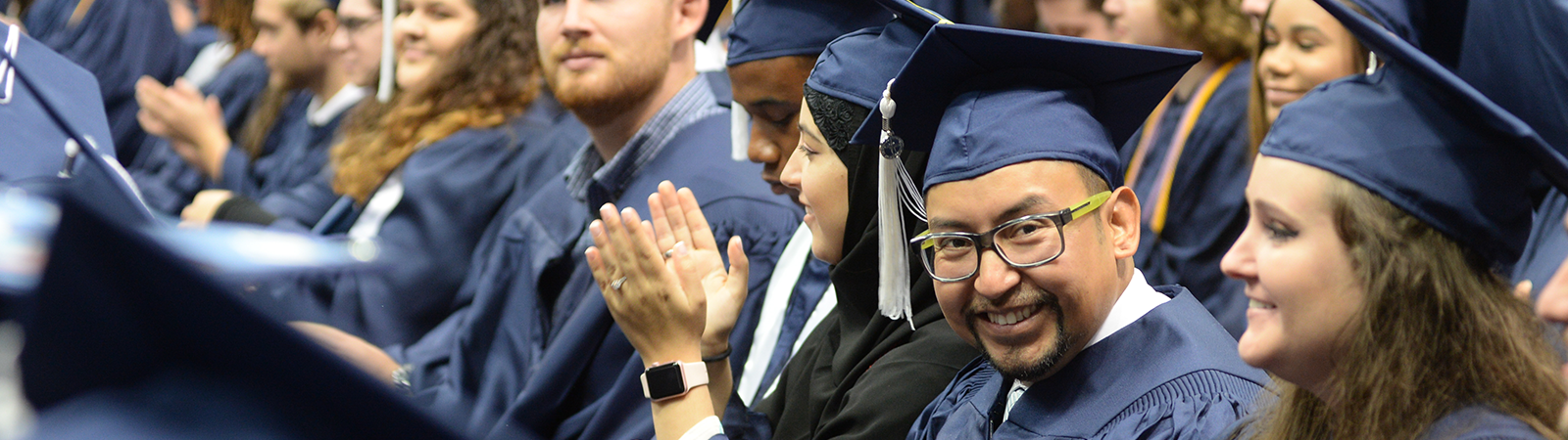 UNF graduates on commencement day waiting to receive their diplomas