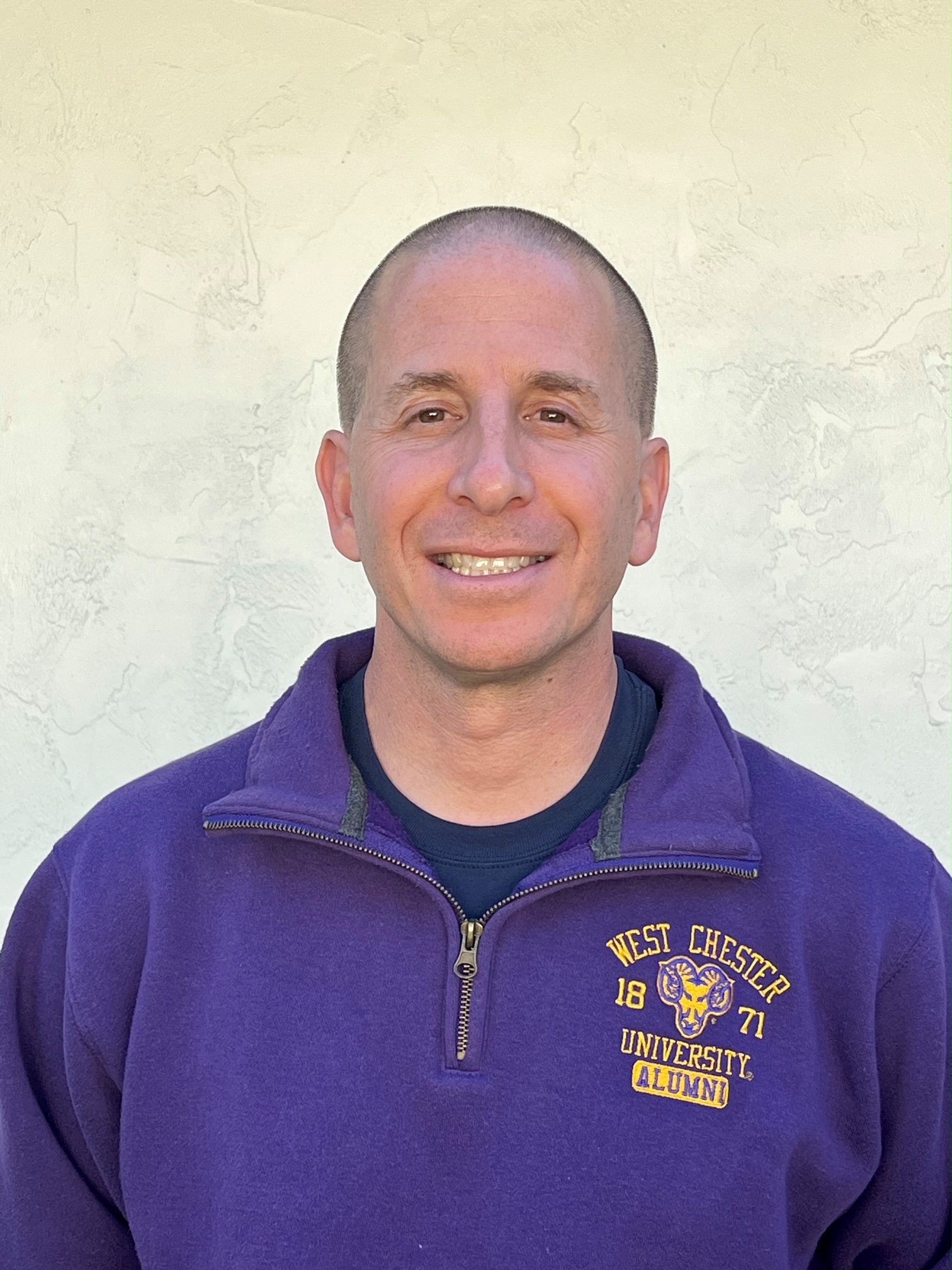 Dr. Hirsch's picture with a purple sweater and smiling