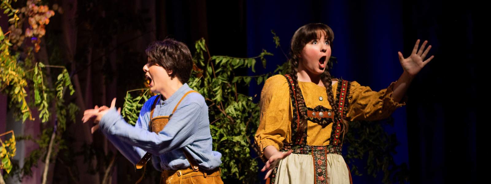 Two students in costume singing.