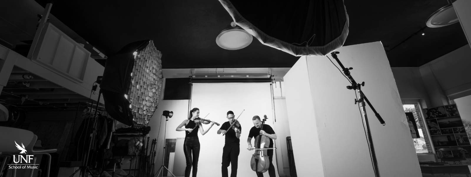 Three people playing string instruments.