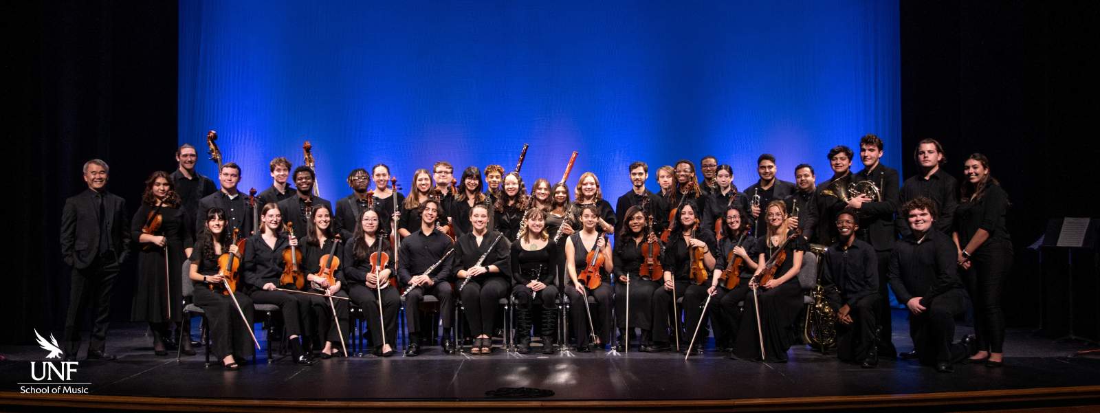 Students with orchestral instruments.