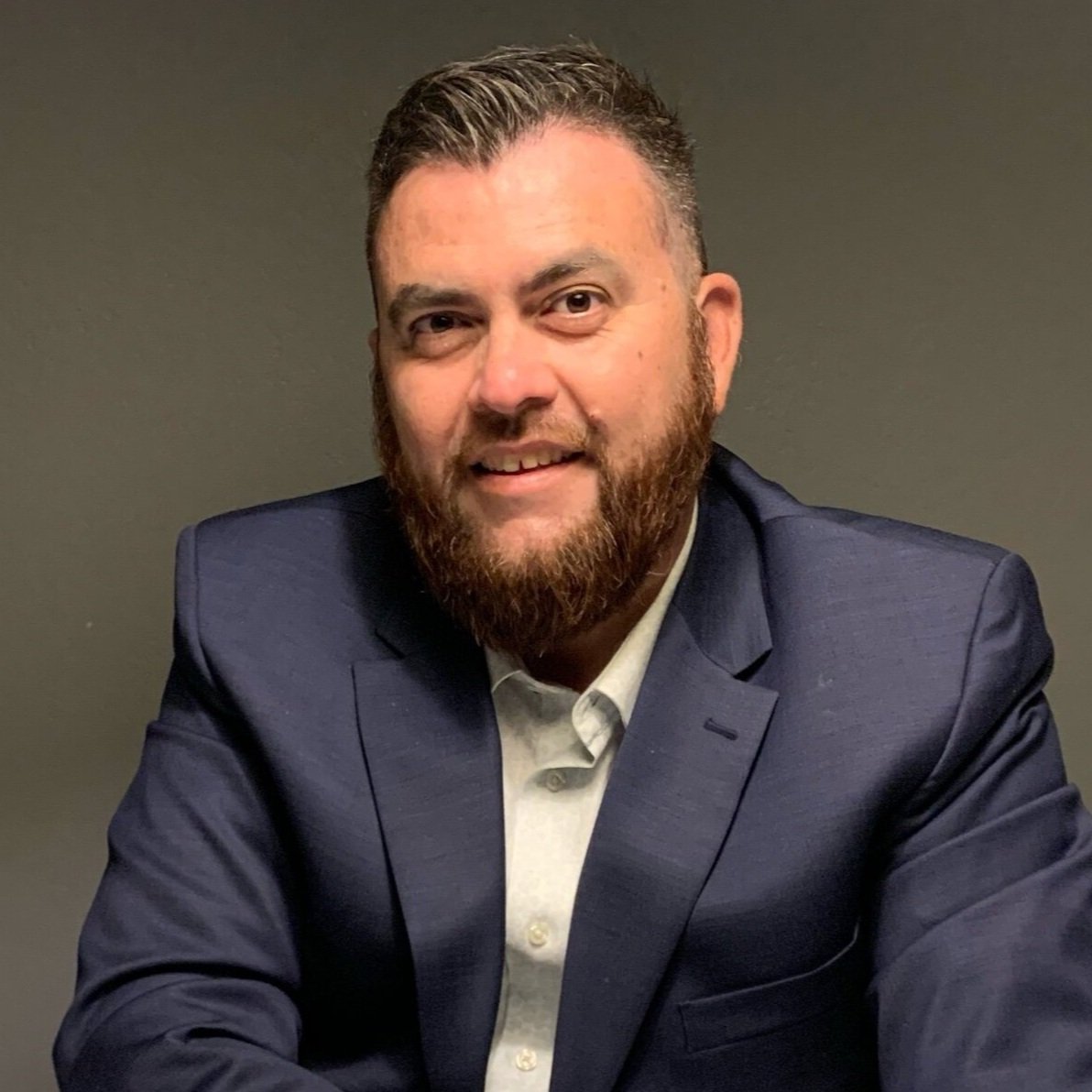 Man in blue suit smiling