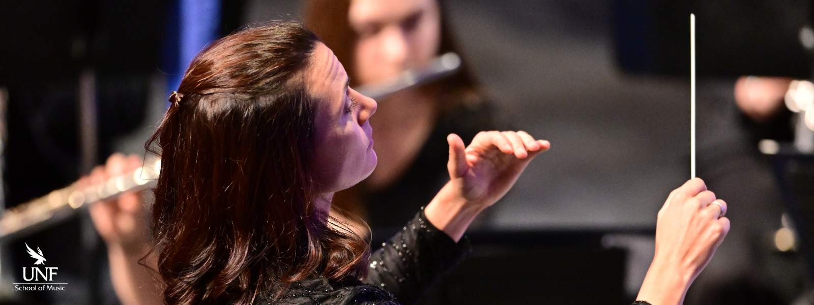 Woman conducting orchestra.