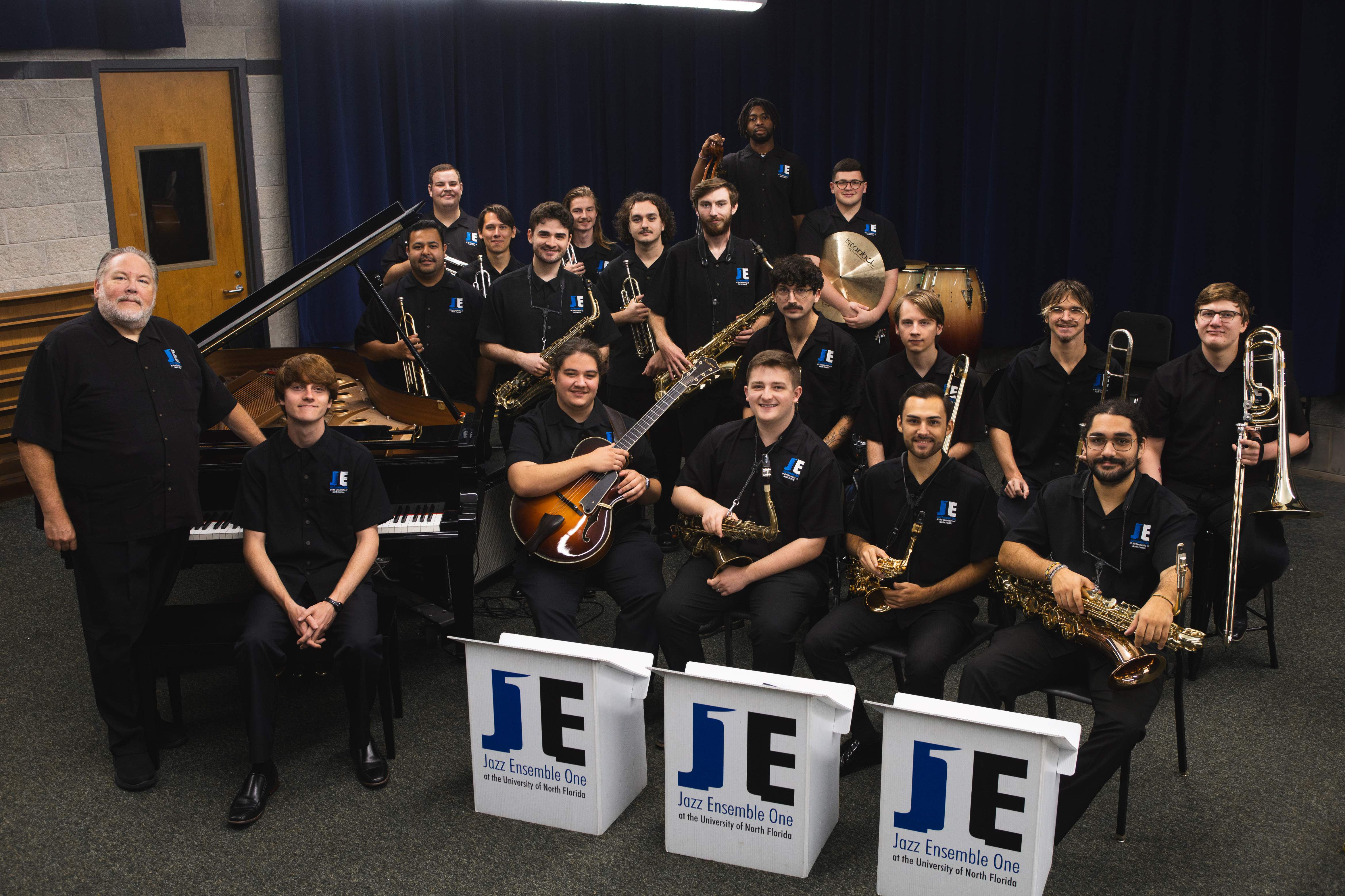 Students of Jazz Ensemble 1 sitting with instruments. 