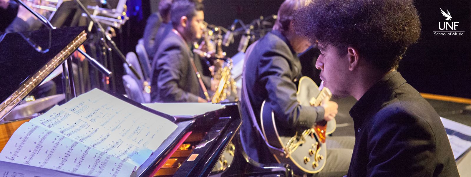 Young man playing piano on stage.