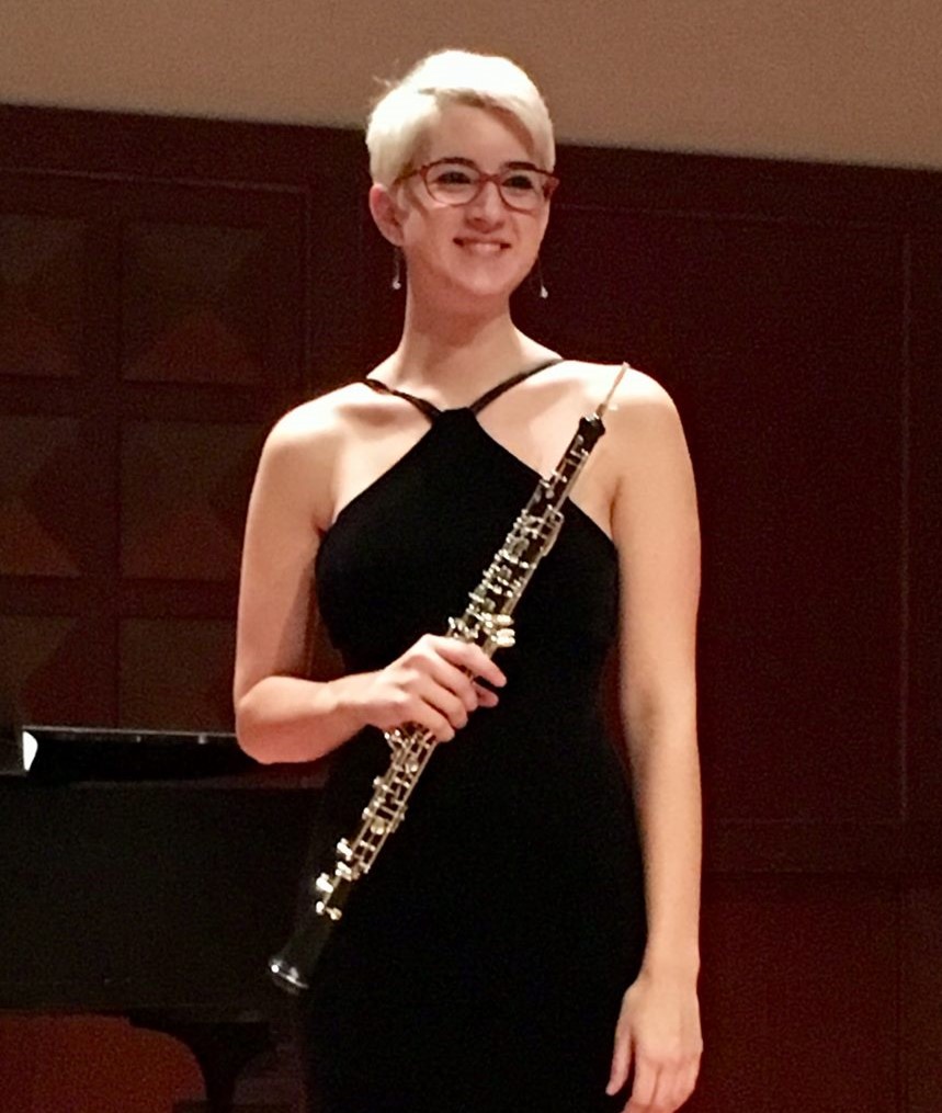 Woman in black gown holding an oboe