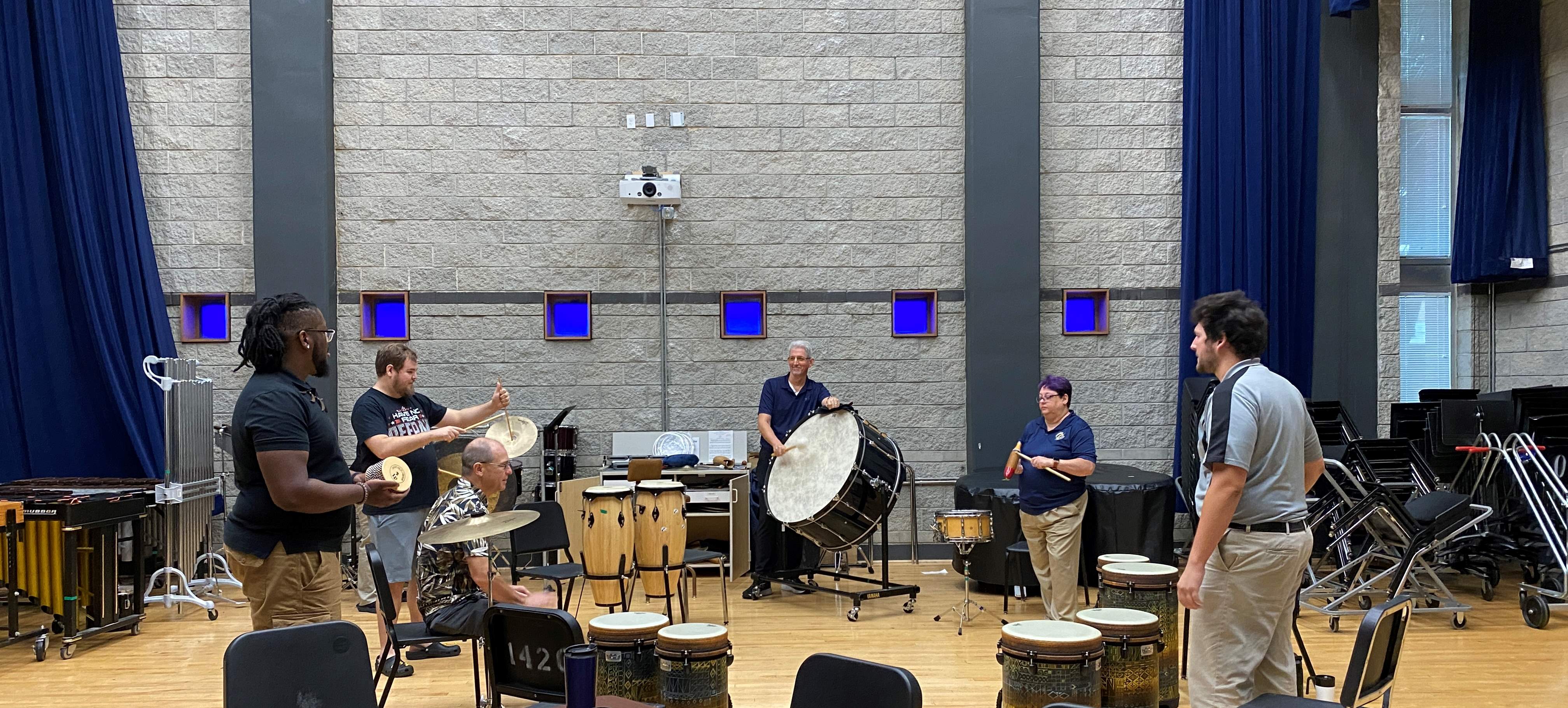 Students playing various percussion instruments.