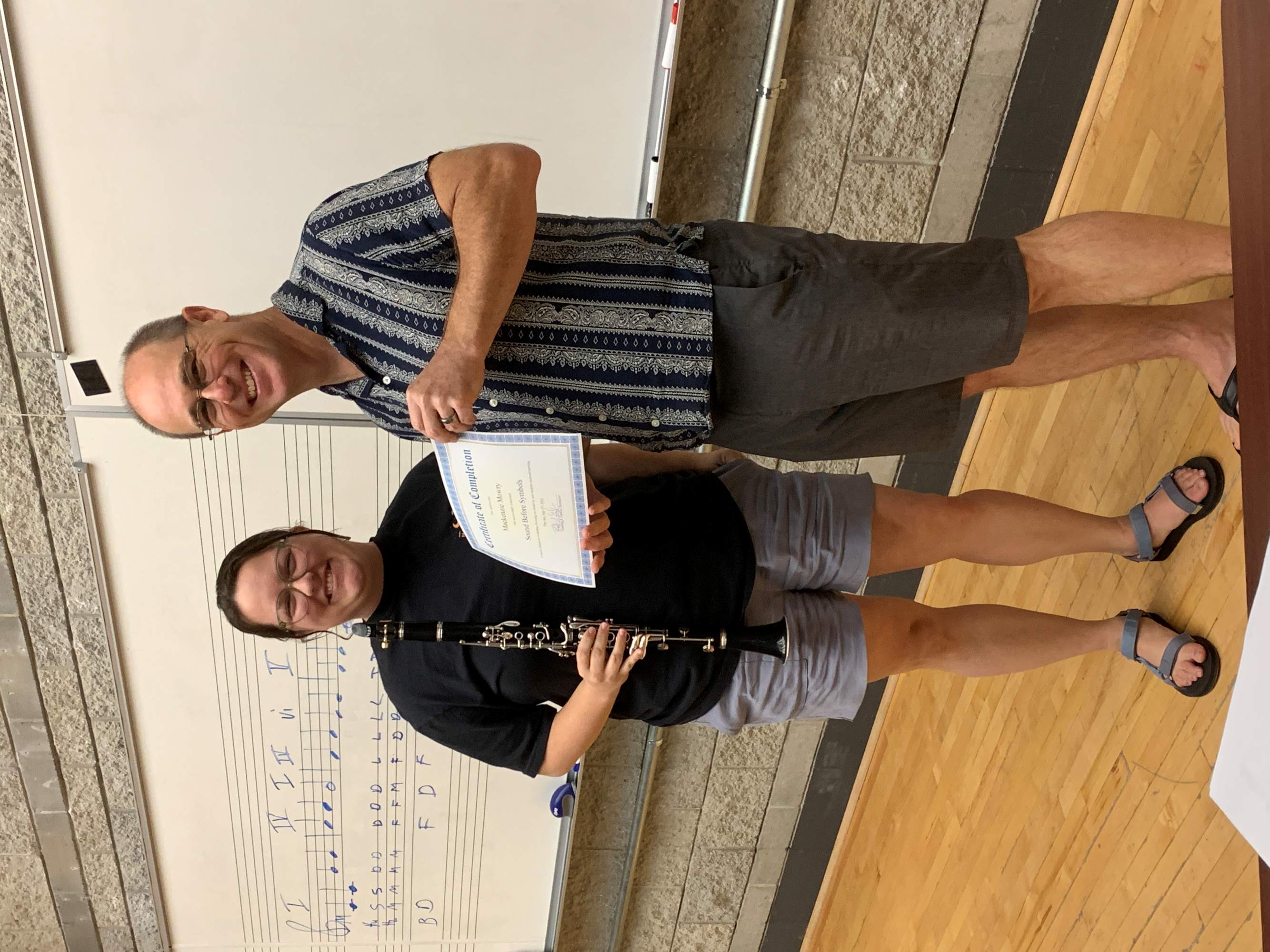 Student and teacher holding certificate