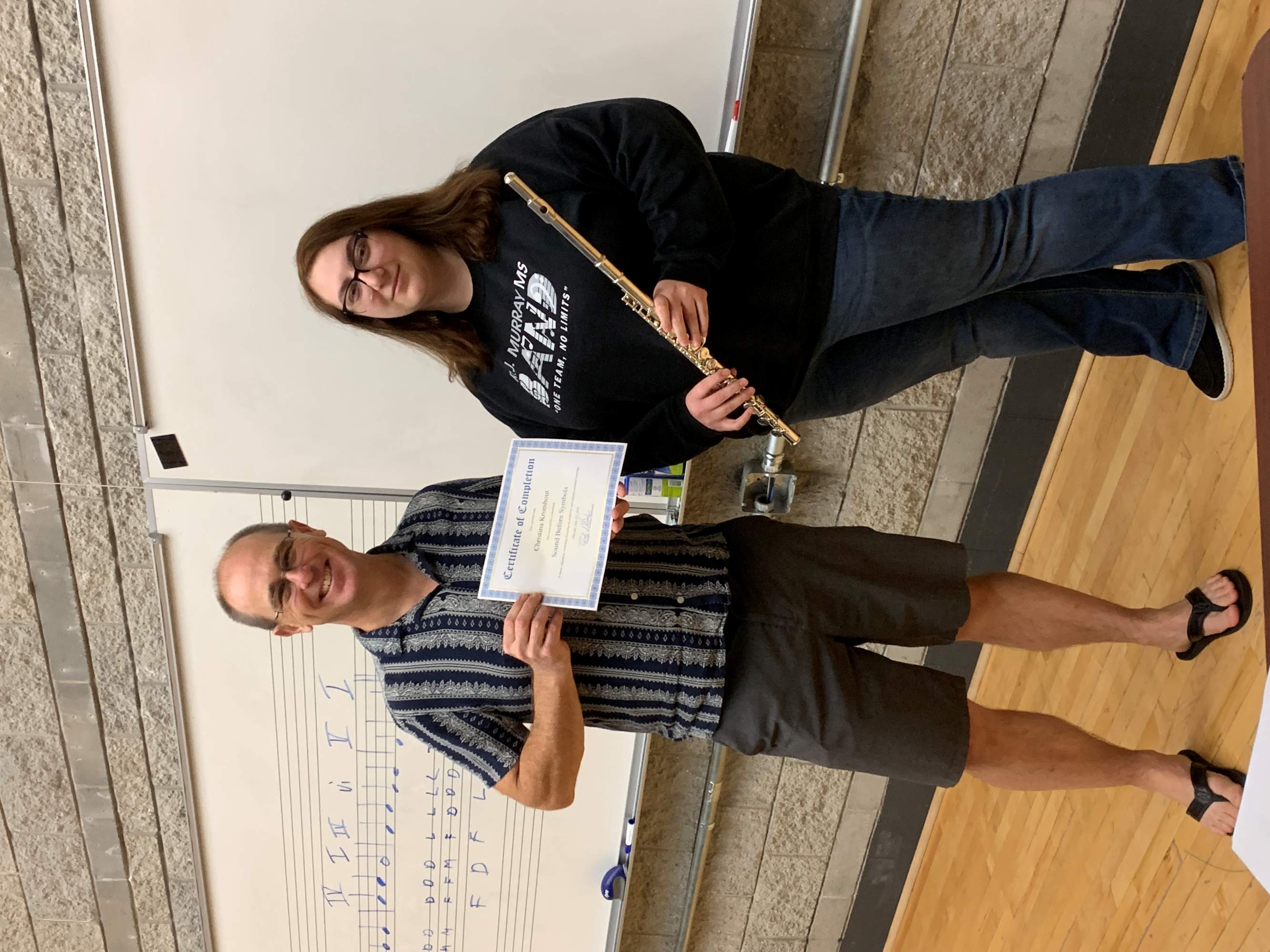 Student and teacher holding certificate