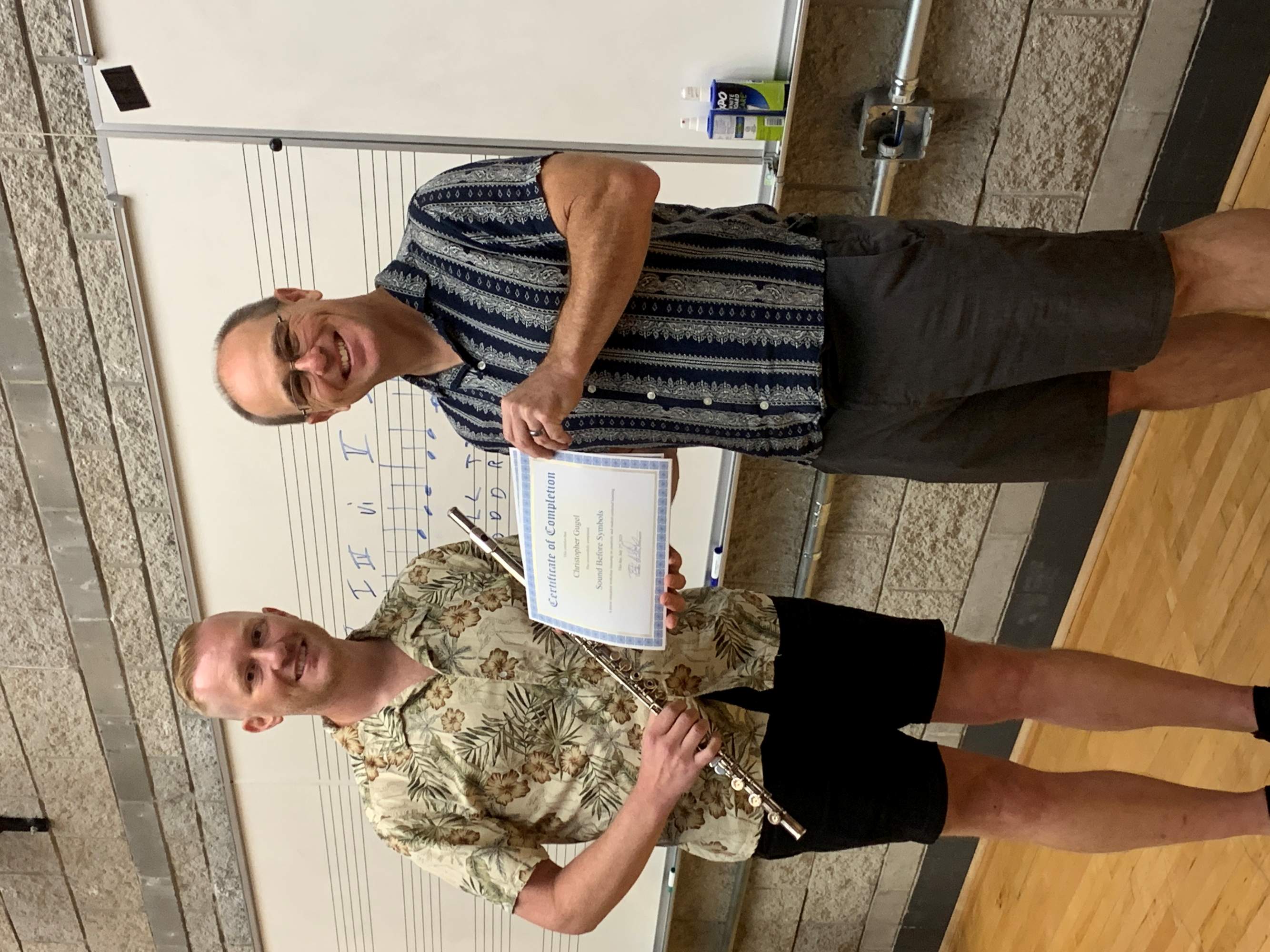 Student and teacher hold certificate
