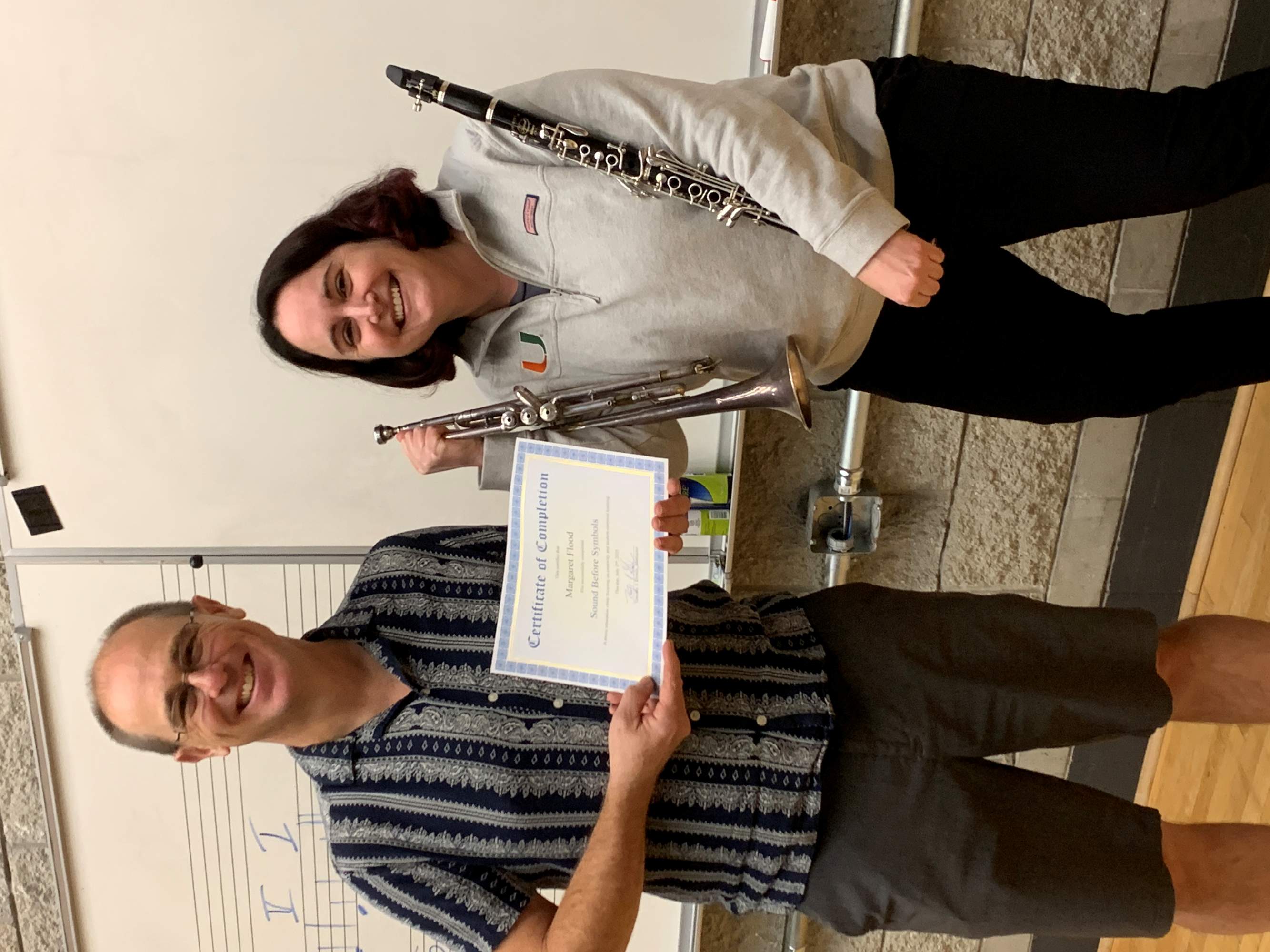 Student and teacher hold certificate