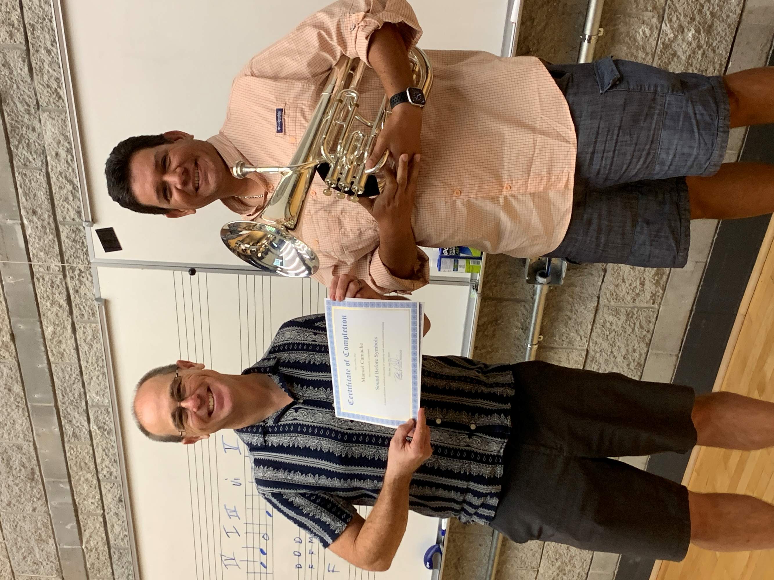 Student and teacher hold certificate