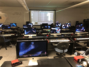 Students playing keyboards in music lab